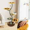A cat tree designed to look like a sunflower, with a cat resting on one of the platforms. The image also includes decorative elements and text. Podgląd zdjęcia produktu