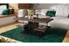 A modern living room scene featuring a coffee table with decorative items and a sofa in the background. Produktbild-Vorschau