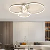 A modern living room with a sectional sofa and a unique ceiling light fixture. Podgląd zdjęcia produktu