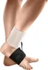 A close-up shot of a person's legs and feet, wearing a black and white ankle brace. Produktbild-Vorschau