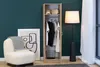 A narrow wardrobe in a room with a chair, artwork, and a floor lamp. Náhled obrázku produktu