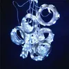 A close-up shot of several coiled strings of white LED lights against a dark blue background. Náhled obrázku produktu