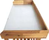 A close-up, angled view of a wooden potting table with a gray surface, set against a white background. Náhled obrázku produktu