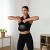 A woman is performing a kettlebell exercise in a home gym setting. Náhľad obrázku produktu