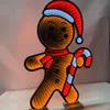 A lit-up gingerbread man decoration with a candy cane. Produktbild-Vorschau