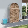 A firewood storage rack filled with wood, placed next to a wall on a patio with a broom and a trash can. Náhled obrázku produktu