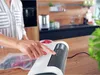 A person using a vacuum sealer machine in a kitchen. Náhľad obrázku produktu