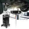 A car oil drainer is shown under a car in a workshop. Anteprima dell’immagine prodotto