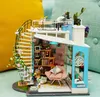 A miniature dollhouse with a spiral staircase and a rooftop garden. Anteprima dell’immagine prodotto