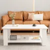 A white coffee table with items on it, placed in front of a brown leather sofa in a living room. Produktbild-Vorschau
