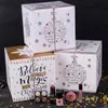 Three decorative advent calendar boxes are stacked and arranged with makeup products in front of them, set against a dark background. Produktbild-Vorschau