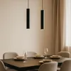 A dining table set for a meal, with two pendant lights hanging above. Náhled obrázku produktu