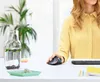 A person's hands using a Logitech ERGO M575 Trackball mouse on a desk, with a water bottle and keyboard visible. Anteprima dell’immagine prodotto
