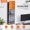 A wall-mounted file organizer with multiple pockets, shown in an office setting with a computer and desk. Náhľad obrázku produktu