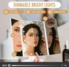 A woman is using a tri-fold makeup mirror with LED lights, demonstrating its features like dimming and magnification. Produktbild-Vorschau