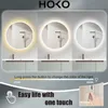 A bathroom vanity with three illuminated mirrors showing different light temperatures. Anteprima dell’immagine prodotto