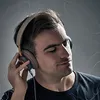 A man wearing headphones and listening to music. Náhled obrázku produktu