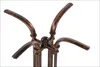 Close-up of the top part of a metal table base with four curved legs. Podgląd zdjęcia produktu