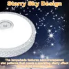 A close-up of a ceiling light with a starry sky design against a dark, star-filled background. Voir les images du produit