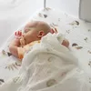 A baby sleeping in a crib with a pacifier and a blanket. Produktbild-Vorschau