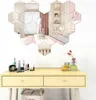 A vanity table with makeup and perfume, with a hexagonal mirror arrangement on the wall above it. Náhled obrázku produktu