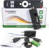 A product shot of an Android TV box and its accessories, laid out on a white surface with a green and white box in the background. Anteprima dell’immagine prodotto