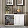 A white sideboard with sliding doors, featuring shelves with books and decorative items, set against a wood-paneled wall. Náhľad obrázku produktu