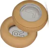 Two tan-colored ear pads for headphones are shown against a white background. Produktbild-Vorschau