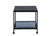 A black metal side table with a glass shelf and wheels, shown against a white background. Produktbild-Vorschau