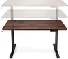 A height-adjustable desk with a wooden top and black metal legs, shown in its lowest position. Náhľad obrázku produktu