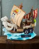 A decorative perpetual calendar shaped like a pirate ship, sitting on a wooden surface with a textured wall in the background. Náhled obrázku produktu