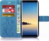 A blue flip case for a smartphone, showing credit cards and euro banknotes inserted into the case. Produktbild-Vorschau