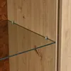A close-up view of a wooden cabinet with glass shelves. Voir les images du produit