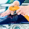 A person is using a portable car wash shower on the hood of a car. Voir les images du produit