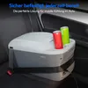 A portable cooler box is secured with a seatbelt in the back seat of a car, with two cans inside. Produktbild-Vorschau