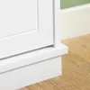 Close-up view of the base of a white cabinet or furniture piece, showing its plinth and how it meets the wooden floor. Produktbild-Vorschau
