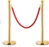 Two golden stanchions with a red velvet rope connecting them, indicating a queue or barrier. Produktbild-Vorschau