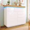 A white high-gloss sideboard with LED lighting and wooden accents, displayed in a room setting. Podgląd zdjęcia produktu