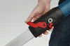 A close-up of a hand holding a tool with a red lever. Podgląd zdjęcia produktu