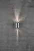 A silver cylinder-shaped wall light mounted on a textured gray concrete wall, emitting light upwards and downwards. Anteprima dell’immagine prodotto