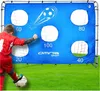 A young boy is kicking a soccer ball at a blue target mat with numbered holes. Náhľad obrázku produktu