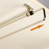 A close-up view of a retractable clothes hanger holder mounted under a shelf or cabinet. Náhľad obrázku produktu