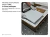 A person in gloves is packing a white furniture piece into a cardboard box with protective foam. Produktbild-Vorschau