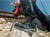 A person wearing work boots and black pants is using a jackhammer to break rocks. Anteprima dell’immagine prodotto