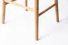 Close-up view of the wooden legs and support structure of a bar stool. Produktbild-Vorschau