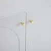 A close-up view of two white cabinet doors with gold knobs. Produktbild-Vorschau