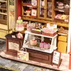 A miniature bakery display with various sweets and pastries. Anteprima dell’immagine prodotto