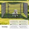 A puppy is inside a metal playpen on a grassy lawn. Voir les images du produit