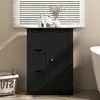 A black bathroom cabinet with drawers and a door, placed in a bathroom setting. Náhled obrázku produktu