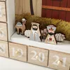 A close-up view of a wooden advent calendar with nativity figures and numbered drawers. Anteprima dell’immagine prodotto